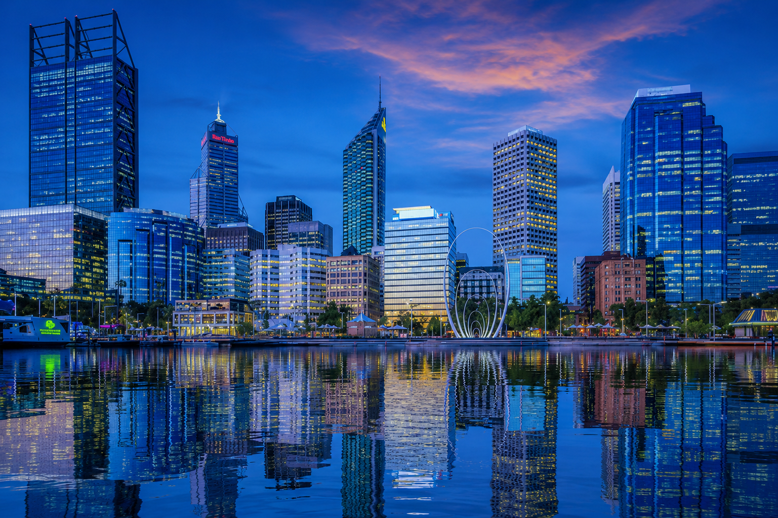 City skyline at twilight with waterfront reflections - JANIX Commercial Cleaning Perth